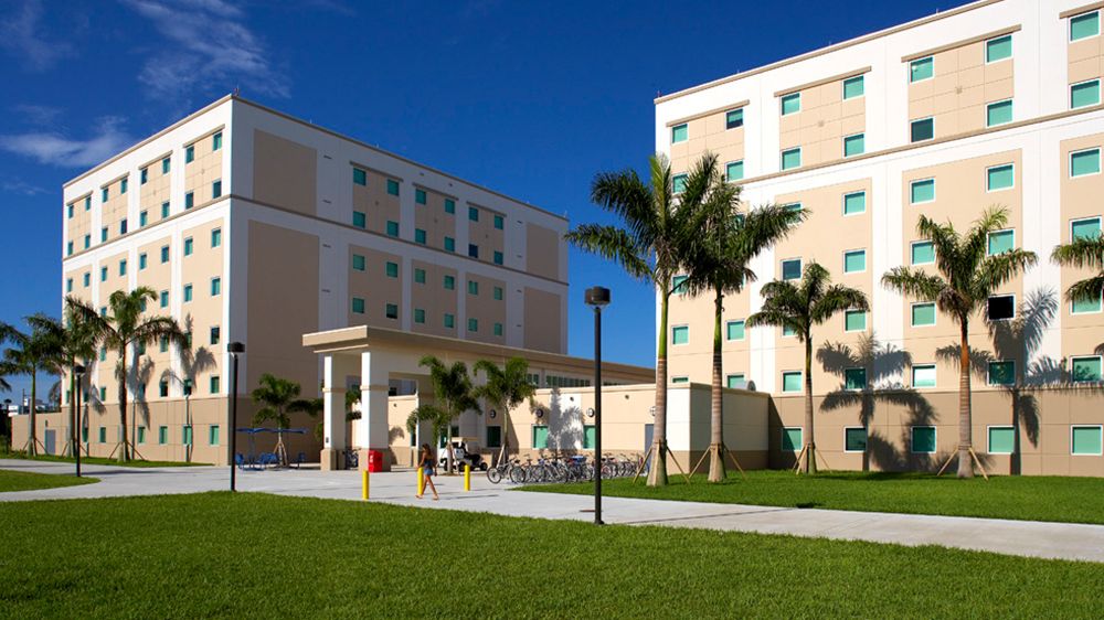 Glades Park Towers, FAU residence-hall towers in Boca Raton, with palm trees and a lawn in front of the entrance