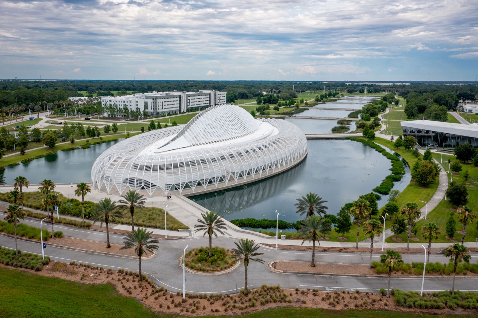 Aerial view of the Florida Polytechnic University campus in Lakeland, with Santiago Calatrava's IST Building surrounded by lakes and green space
