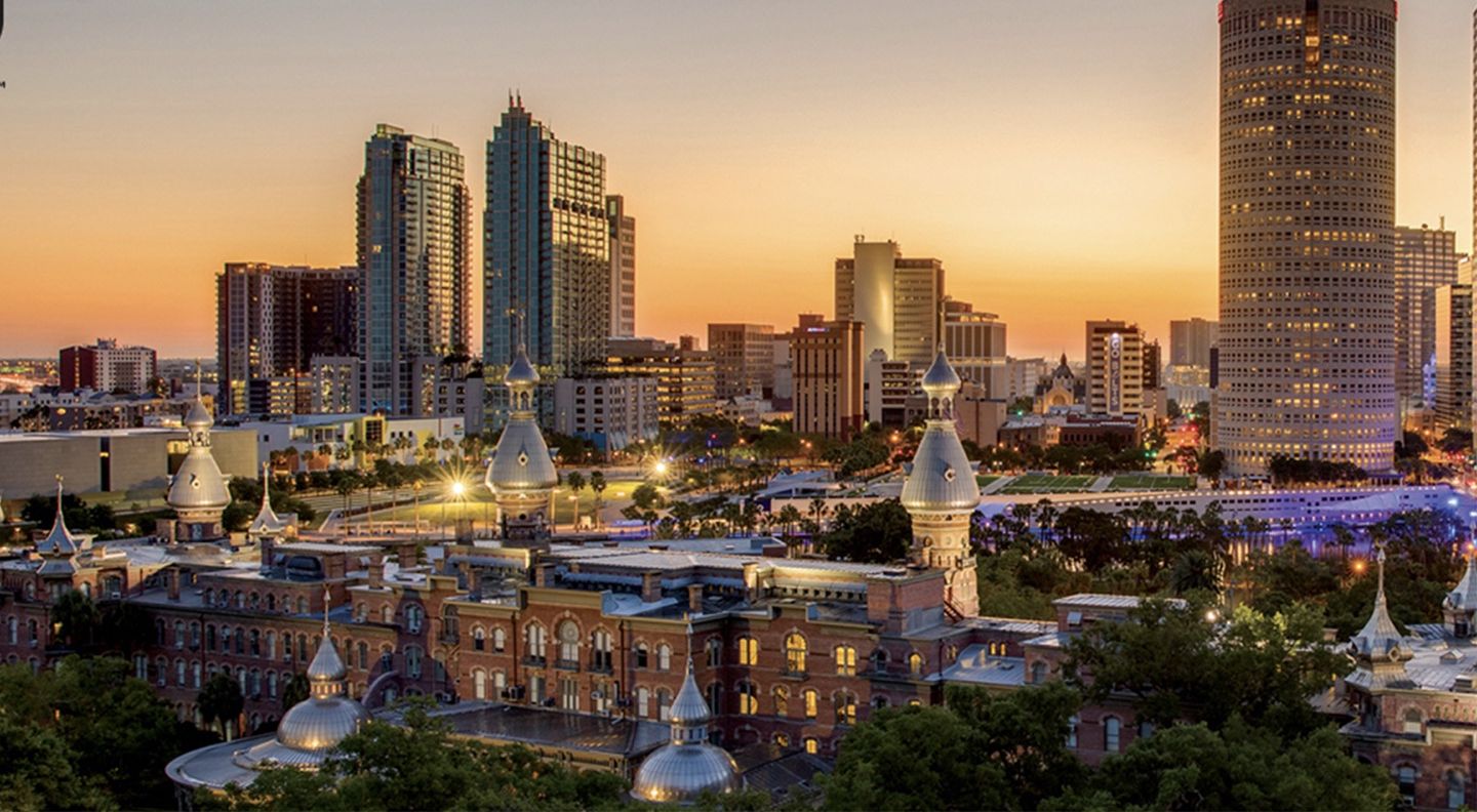 Skyline do centro de Tampa ao pôr do sol, com os minaretes do Plant Hall em primeiro plano