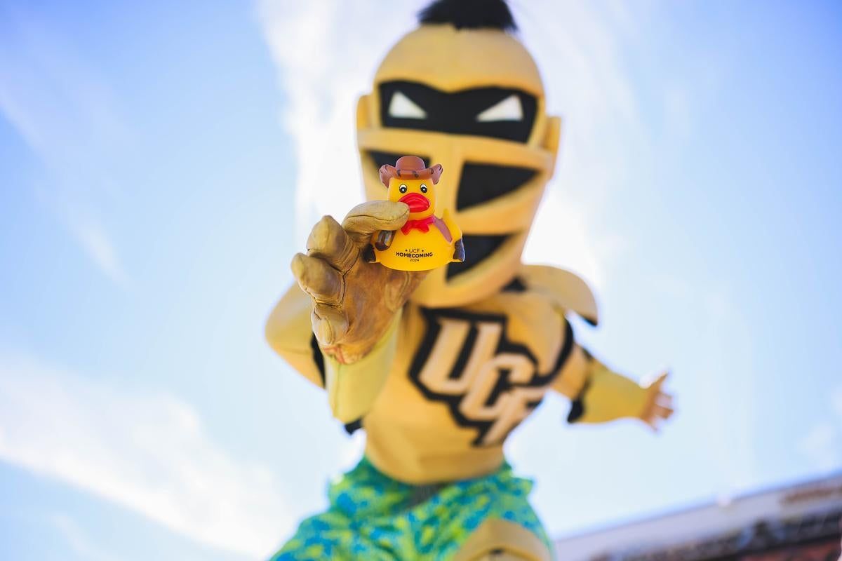 Knightro, UCF's mascot, holding a cowboy-hat rubber duck at Spirit Splash 2024