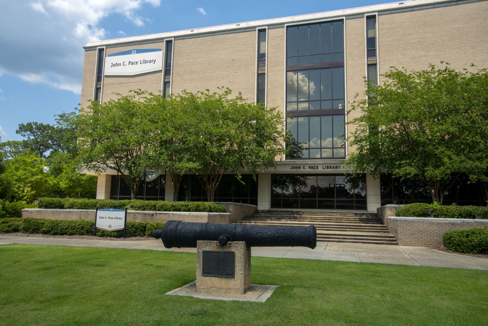 Front of the John C. Pace Library, UWF's main library, with the historic cannon on the lawn in front of the entrance